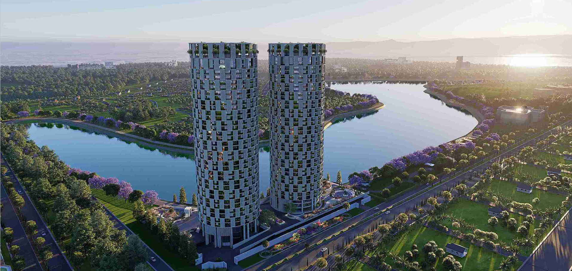 Aerial sunrise view of Green World twin towers beside the lake with jacaranda blooms